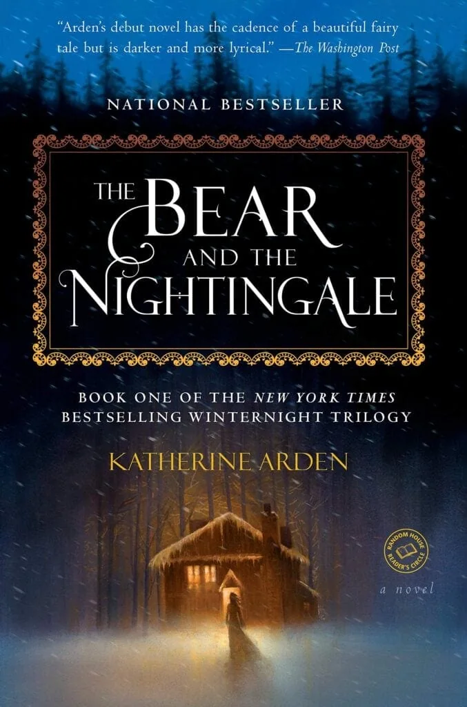 Front cover of the book The Bear and the Nightingale by Katherine Arden. A girl stands silhouetted against the light of a cozy cabin surrounded by forest and snow.