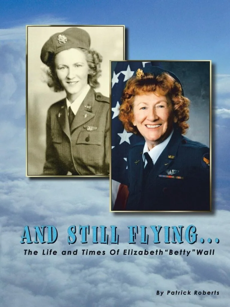 Cover of 'And Stilly Flying...The Life and Times of Elizabeth 'Betty' Wall' by Patrick Roberts.

Two photos are on the cover. One that is Betty's official WASP photo, and the other of her in uniform in her latter years in life.